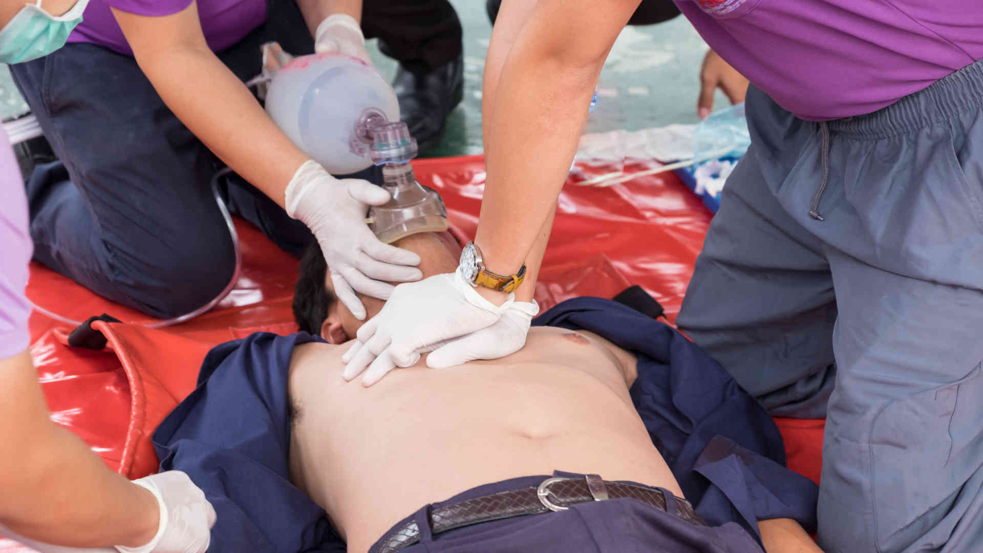 Person in cardiac arrest receiving chest compressions and bag-mask ventilation