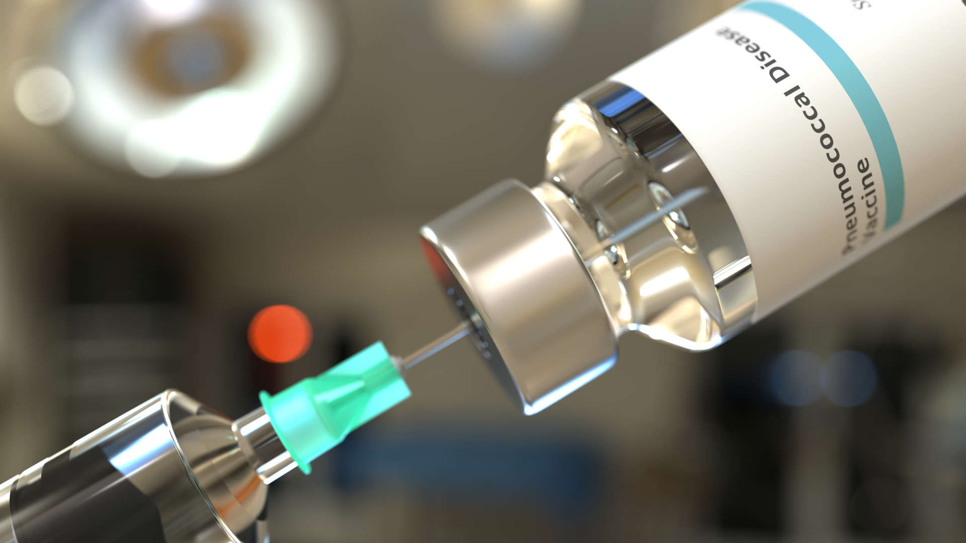 Ampoule containing pneumococcal vaccine being aspirated